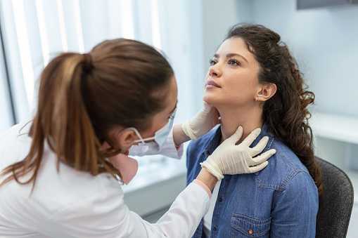 Doctor examining patient's throat